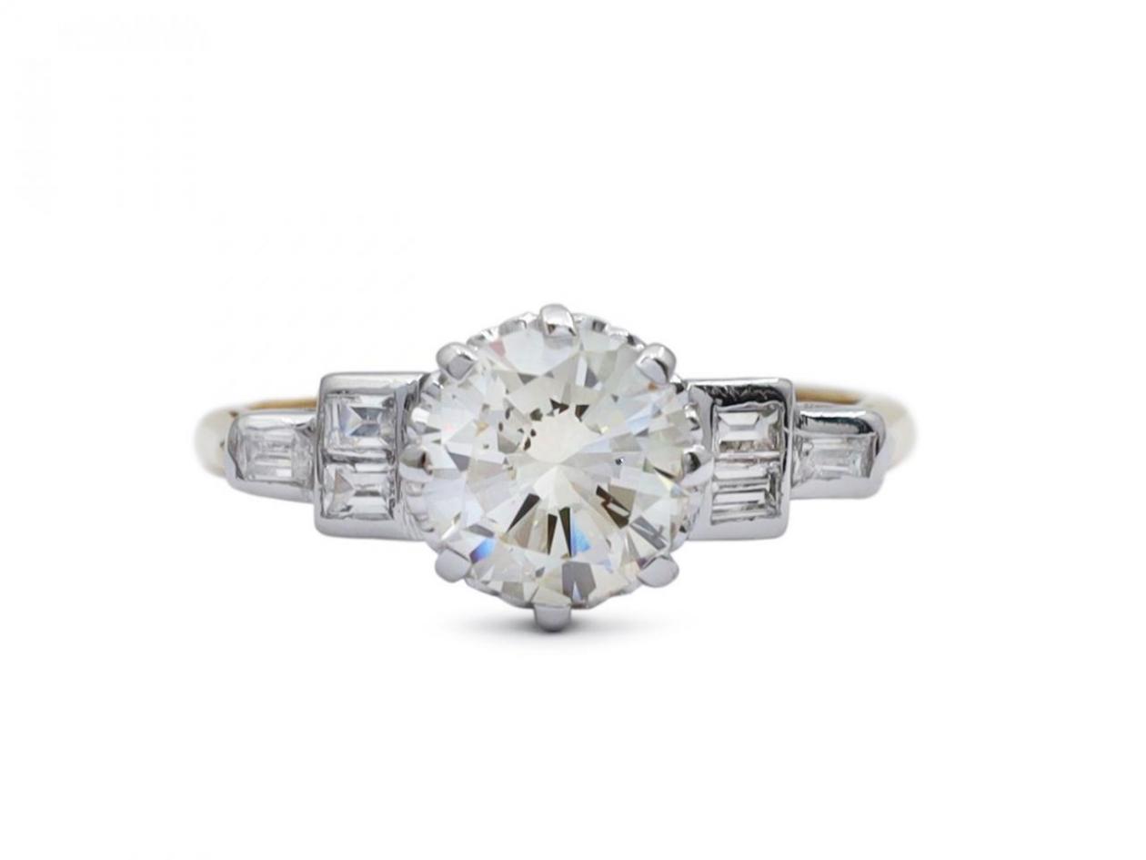 1950s 1.30ct round diamond solitaire with baguette shoulders in gold