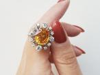 Modern 6.52ct fancy yellowish orange sapphire and old cut diamond cluster ring
